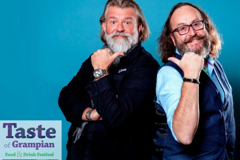 Photograph of the Hairy Bikers, Si King and Dave Myers on a blue background advertising the Taste of Grampian  festival taking place on 4th June 2022.