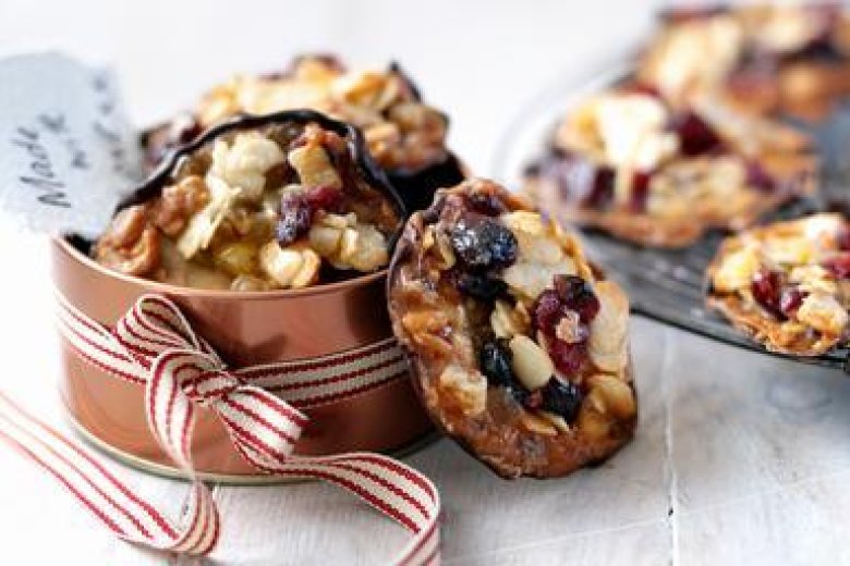 A gift-tagged box with a red and white stripped ribbon showing Sour Cherry and Stem Ginger Florentines