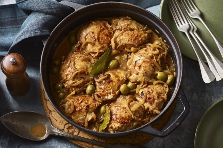 Chicken Yassa , a West African chicken dish served in a casserole dish on a table