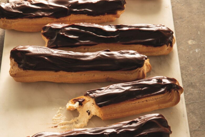 A tray of luxurious chocolate eclairs.